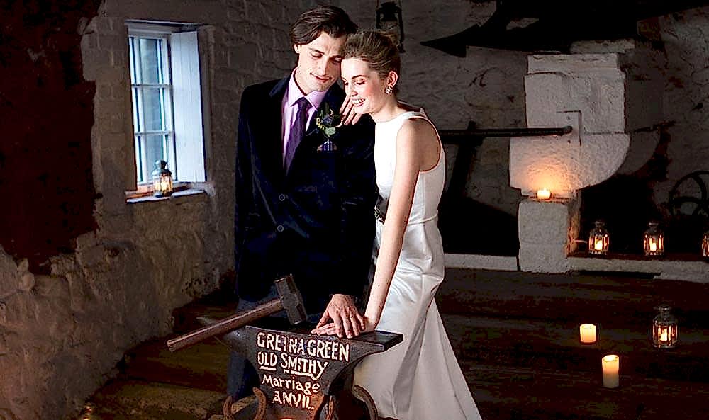 Wedding photo in the Original Marriage Room of the Famous Blacksmiths Shop Gretna Green with the Anvil